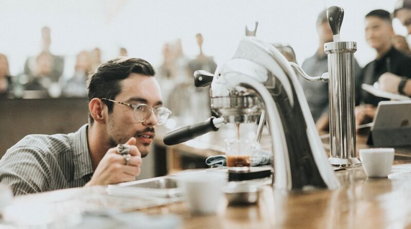 Man looking at coffee pouring from the coffee machine.